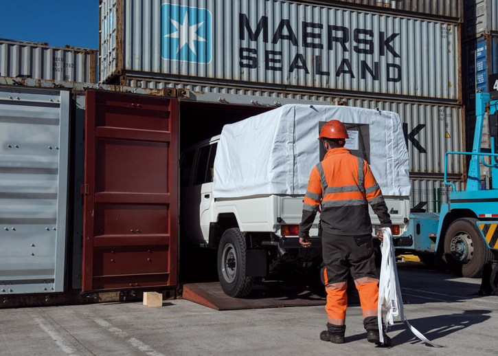 TGS truck being put into a cargo container