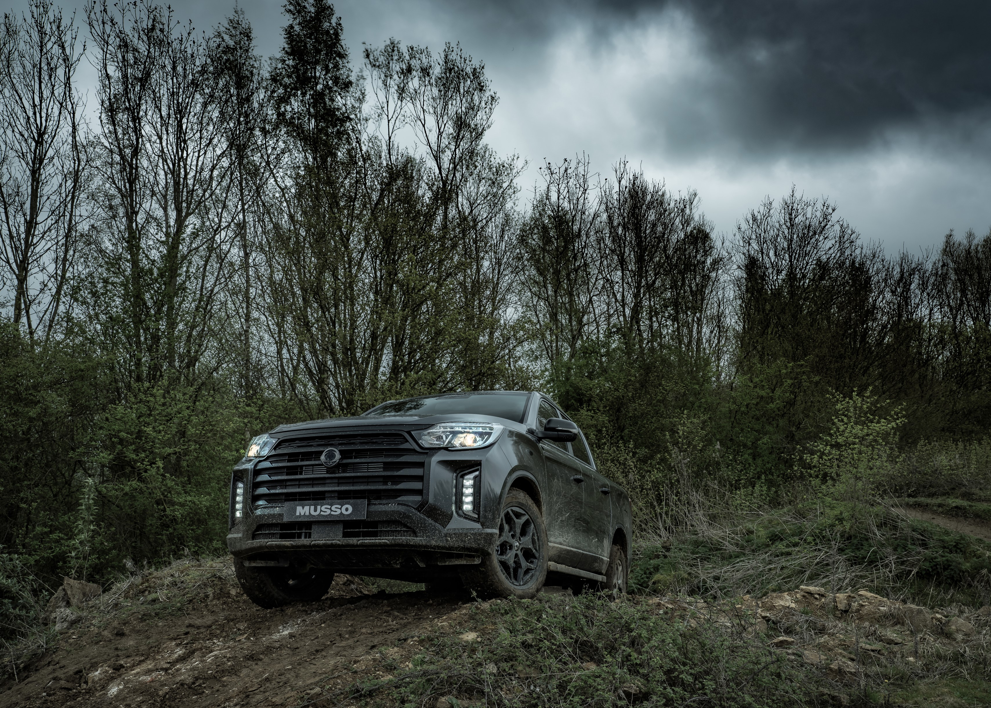 SsangYong Musso off roading in a woodland area