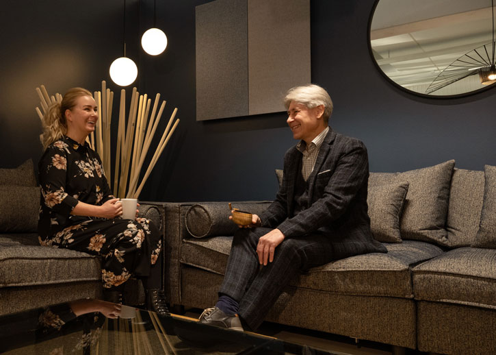 Two people sat on sofas in discussion